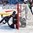 BUFFALO, NEW YORK - DECEMBER 28: Slovakia's Erik Smolka #4 crashes into USA goalie Joseph Woll #31 during the preliminary round of the 2018 IIHF World Junior Championship. (Photo by Andrea Cardin/HHOF-IIHF Images)

